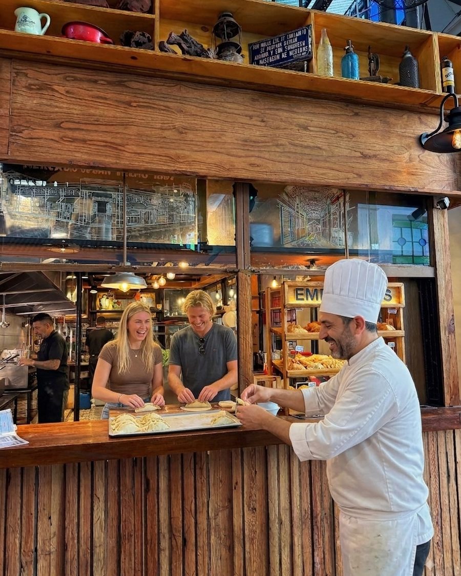 Travelers making their own empanadas during a hands-on class in San Telmo, Buenos Aires
