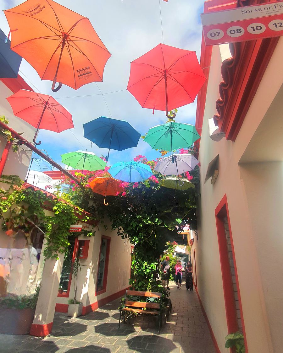Colorful umbrellas hanging over a passage in San Telmo